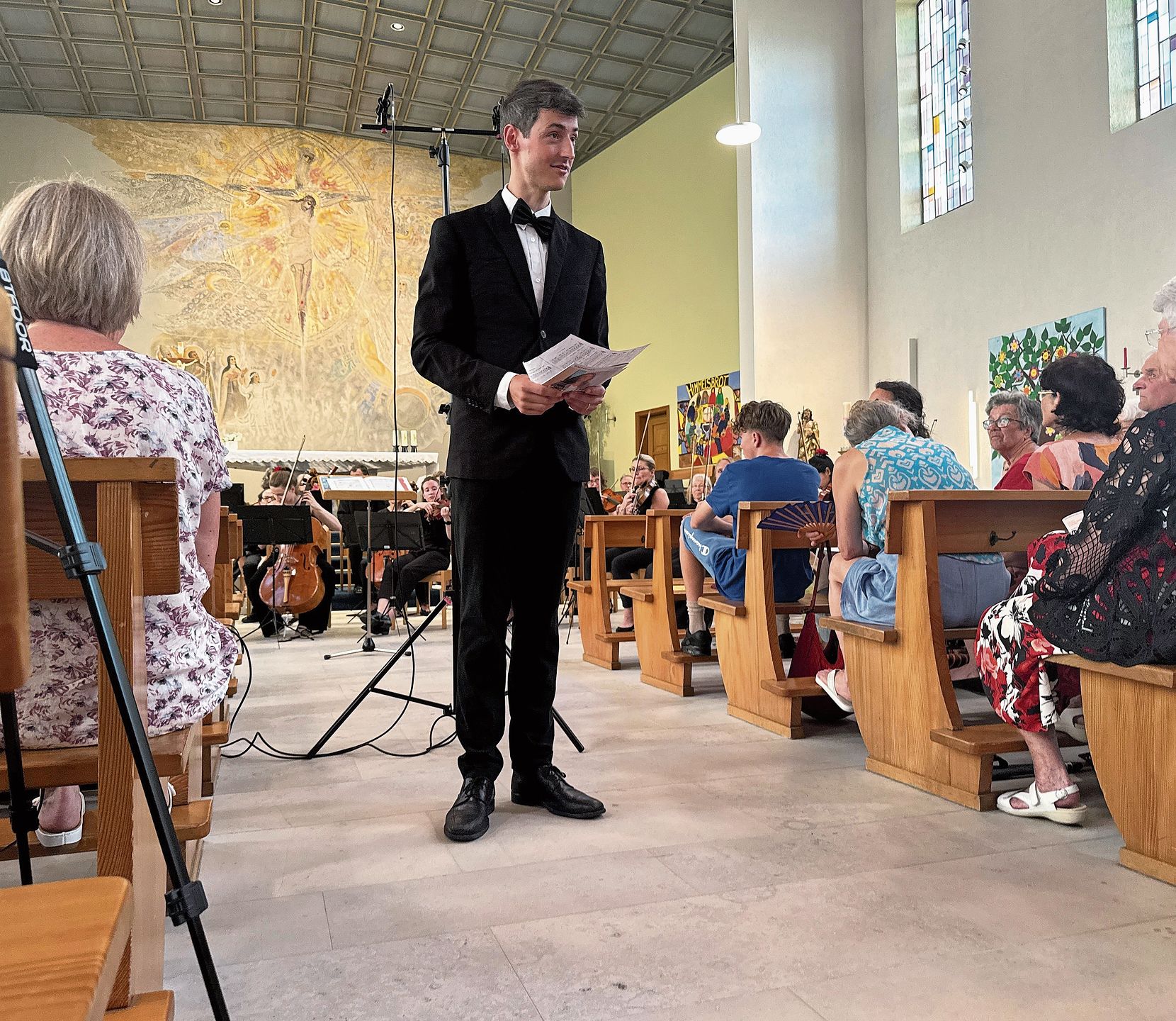 Der Dirigent lädt das Publikum zum Mitsingen ein. Fotos: E. Bachmann